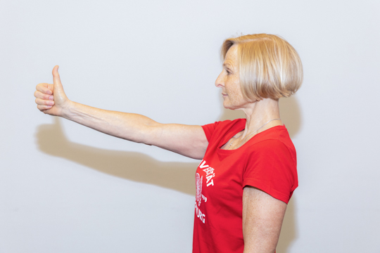 Thumb peeking Eye relaxation exercise Thumb peeking: A person is pictured from the side with one arm stretched out in front, thumb extended, and their eyes on their thumb.