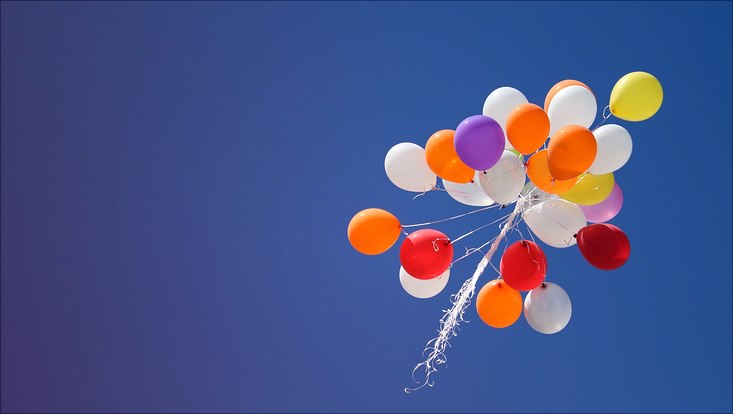 Foto von bunten Luftballons im blauen Himmel.
