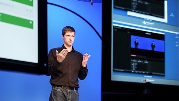 A man is filmed signing a contribution for the sign language dictionary