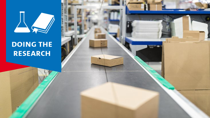 Packages on a conveyor belt in a warehouse