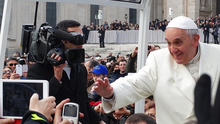 Pope Francis waves to the cameras.