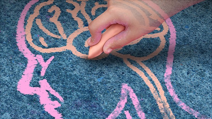 Child drawing a head with chalk.