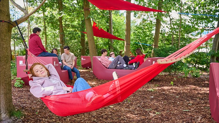 Students hang out in hammocks or on ENZI furniture on the Bahrenfeld campus.