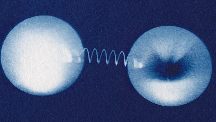 Artistic representation of a connection between a top quark and its antiparticle.