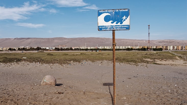 Part of comprehensive preparedness: a tsunami evacuation sign, shown here on the beach in Arica, Chile.