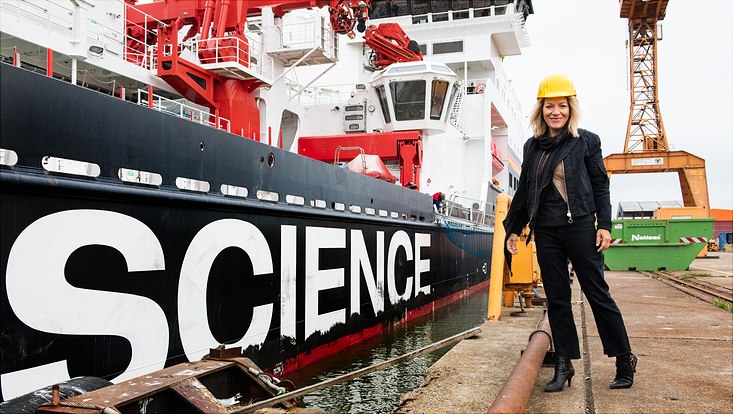 Antje Boetius is standing in front of a ship labeled "Science"