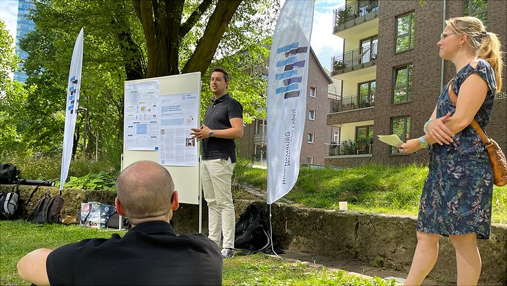 People sitting and standing together in a park