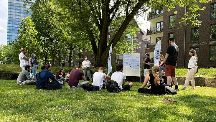 People sitting and standing together in a park