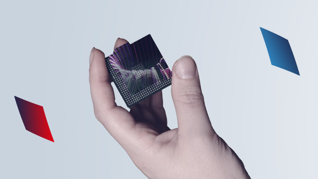 In the center: a hand holding a black square, on which fine resonance waves can be seen. To the left and right of the image are more squares, a red one on the left and a blue one on the right.