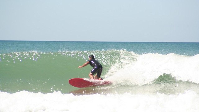 A surfer rides the wave