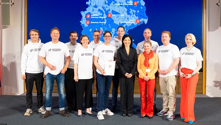Group photo in front of a screen