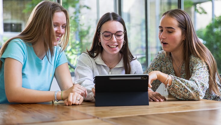 Three women looking at a tablet