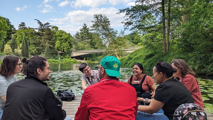 Postdocs chatting by the lake