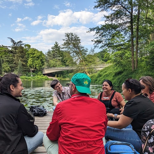 Postdocs chatting by the lake