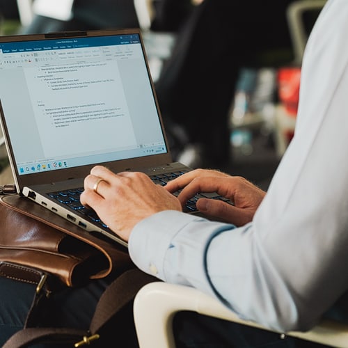 A person writing on a laptop