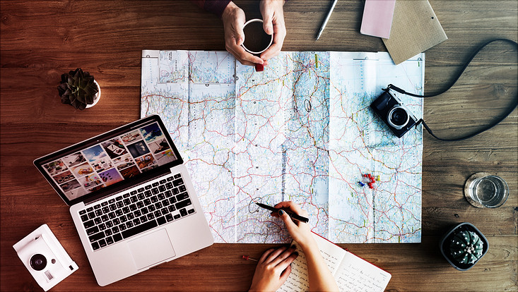 travel planning: map, camera, etc. on a table
