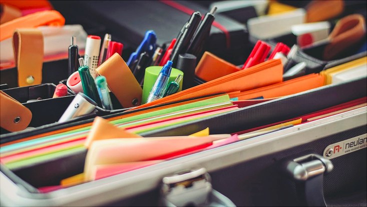 Inhalt eines Methodenkoffers. Viele Stifte, buntes Papier und Post-It Notes